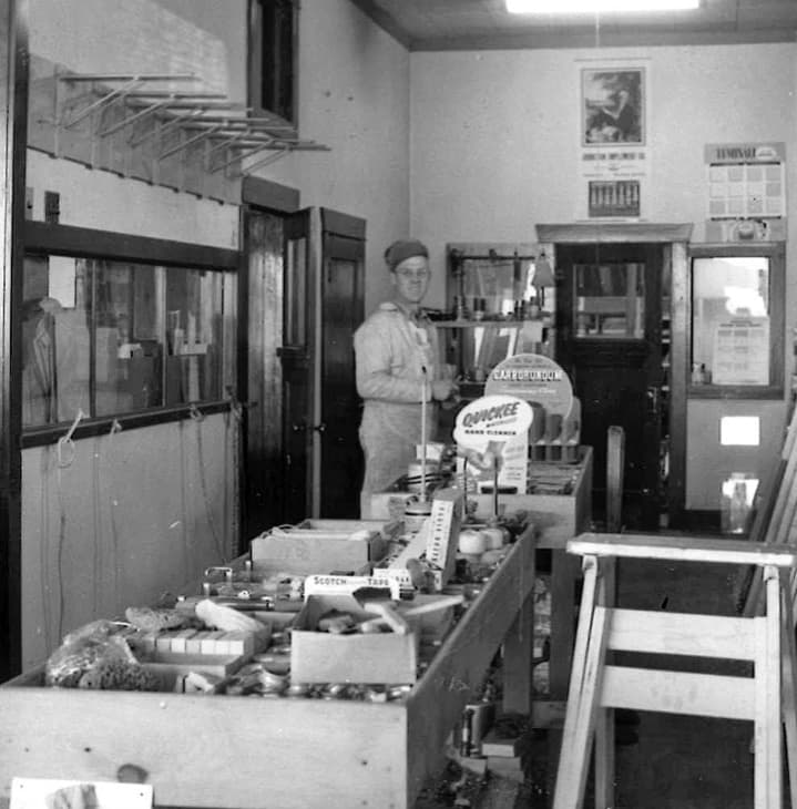 Black and white photo of original Torrington Lumber and Coal Company interior with employee and inventory.