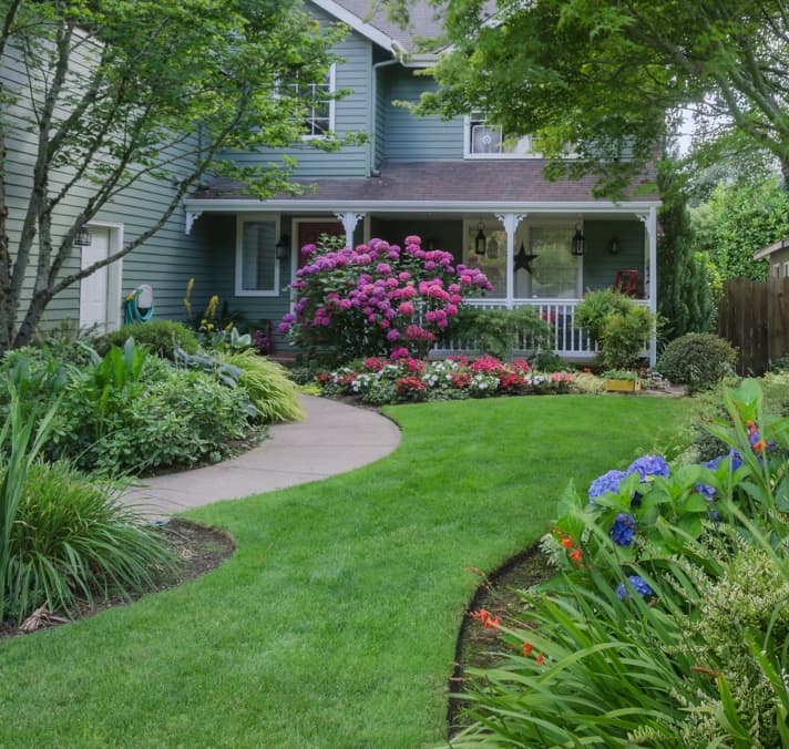 Landscaped yard with home porch exterior.